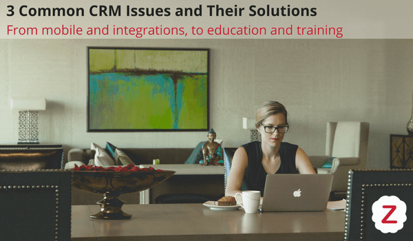 Woman sitting at her desk reading about common crm issues and zoho solutions