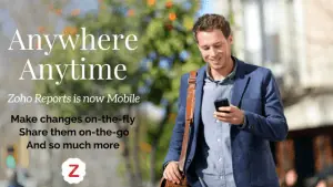 Guy in a nice jacket looking at his Zoho Reports son his mobile phone