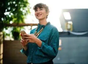 Business woman on phone looking at Zoho mobile application