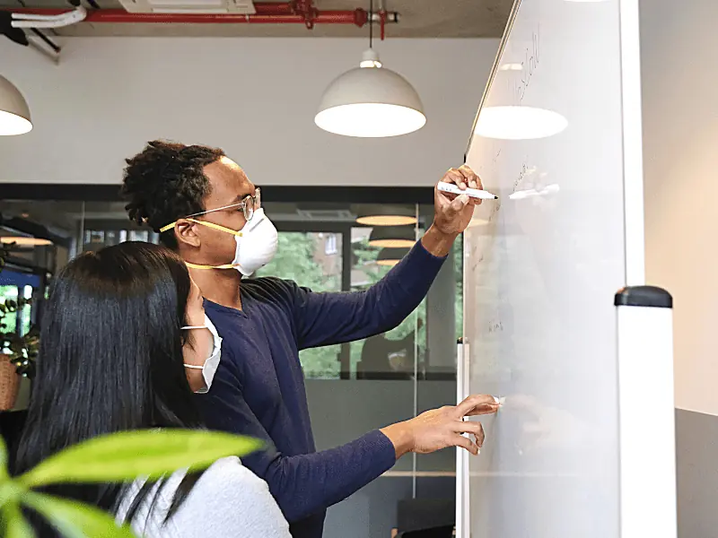 people working on a whiteboard
