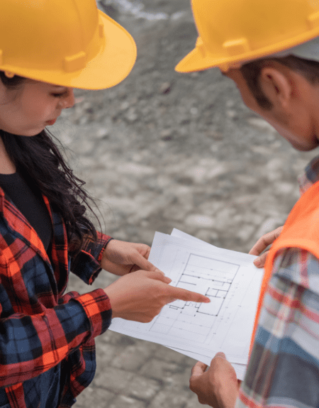 Construction workers review plans