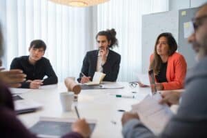 Group of people having a Zoho CRM discussion.